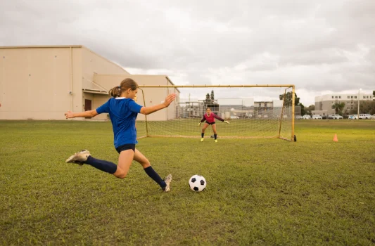 Soccer player striking the ball toward the goal