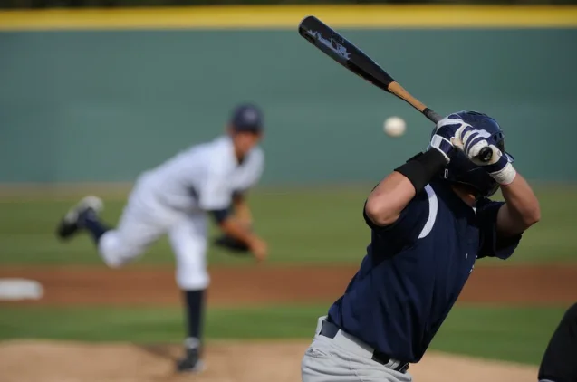 Batter loading his swing as the pitch comes in